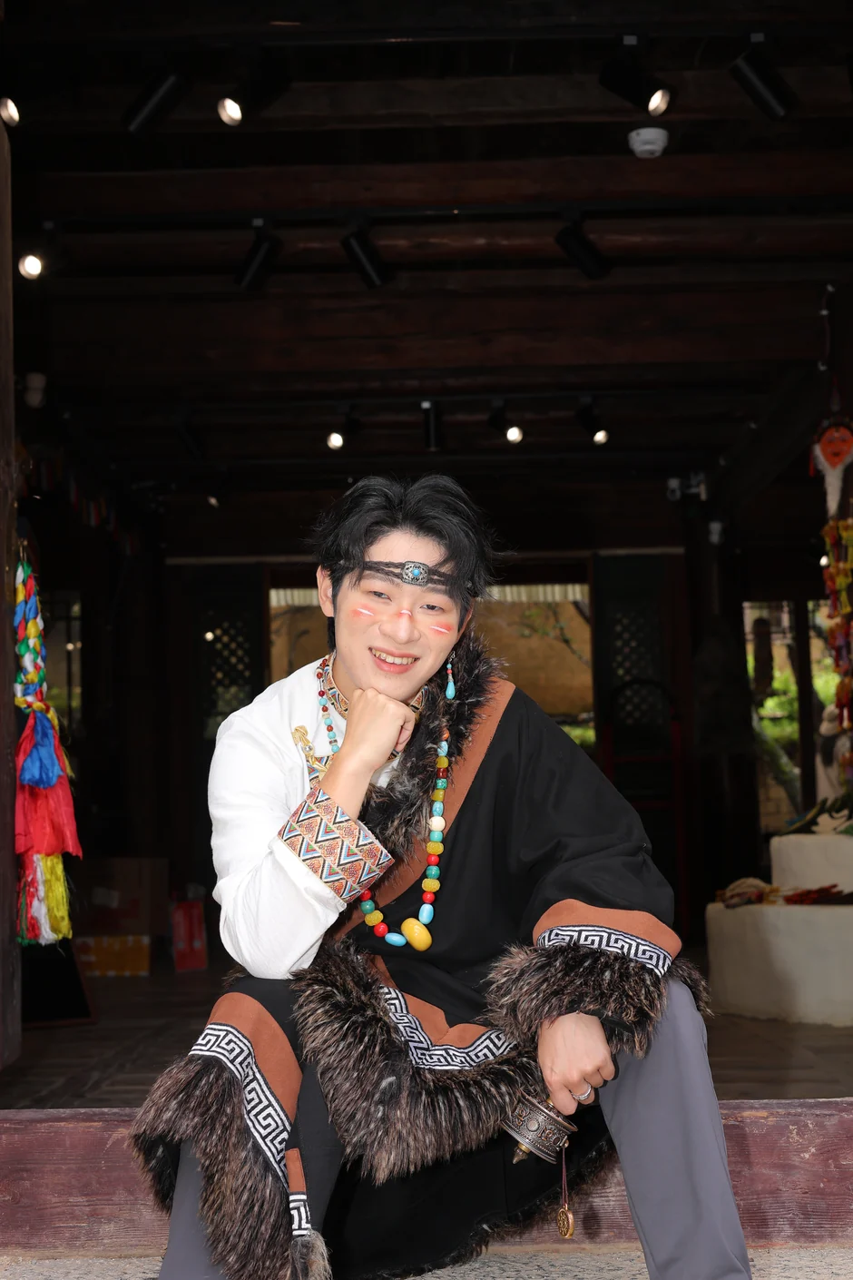 Mark Qiu, seated, photographed indoors.